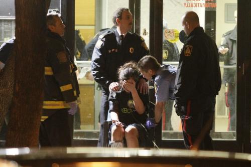 May 1, 2012 - 120501  - Emergency personnel comfort a distraught woman in front of 375 Assiniboine Avenue. A male was taken away by emergency personnel after allegedly falling from a balcony at 375 Assiniboine Tuesday May 1, 2012. John Woods / Winnipeg Free Press