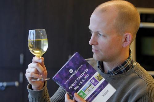 Ben MacPhee-Sigurdson writes about wine in the Winnipeg Free Press. Here he poses with some Canadian wine he is writing about. Photo taken at Madison Square LC. May 3, 2012  BORIS MINKEVICH / WINNIPEG FREE PRESS