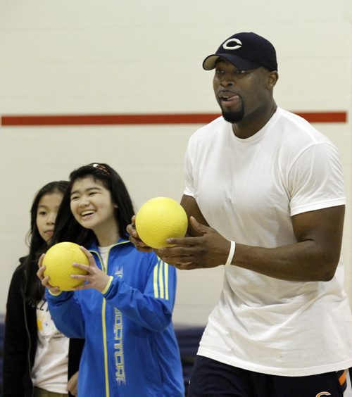 Chicago Bears defensive end Israel Idonije plays dodgeball with students (names withheld, as per the principal's instructions) at Sister MacNamara School on Friday. Idonije was named the schools principal for a day and participated in gym classes with the students throughout the morning. This event was in conjunction with the Israel Idonije Foundation First Down Attendance program, which encourages students to maintain regular school attendance and overall high achievement. May 04, 2012. SARAH O. SWENSON / WINNIPEG FREE PRESS