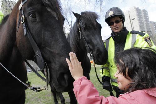 SUNDAY XTRA - Sheyannah Fournier, age 6, pets Titus, while Constable Sherry Blunden holds the reins of Amaro in Central Park on Friday. Blunden and her partner Constable Anna Proskurnik are the only mounted members of the Winnipeg police service. May 04, 2012. SARAH O. SWENSON / WINNIPEG FREE PRESS