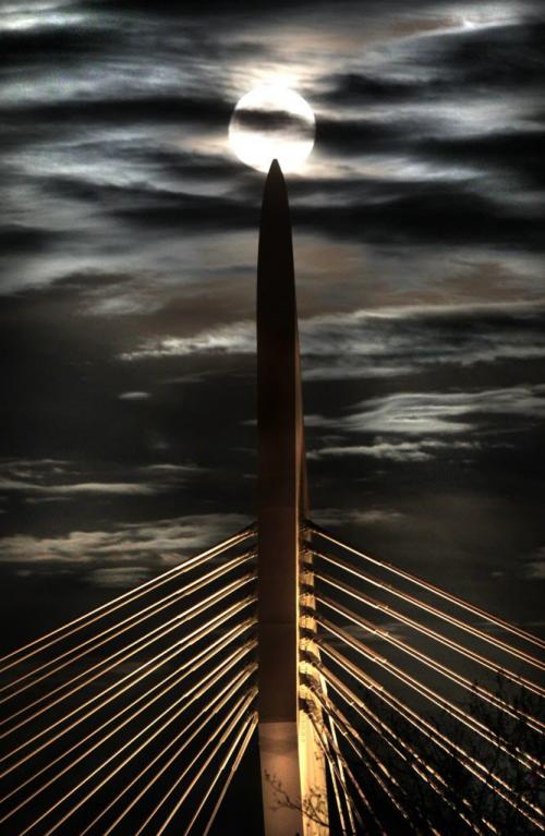 As the moon rises over Winnipeg Saturday evening it seems to have landed on top of the Provencher Bridge .  Standup photo May 05  2012 (Ruth Bonneville/Winnipeg Free Press)