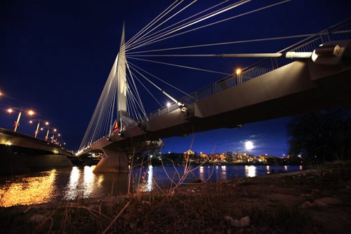 The moon begins to rise next to the Provencher Bridge  in the far right of the scene Saturday night. Standup photo May 05  2012 (Ruth Bonneville/Winnipeg Free Press)