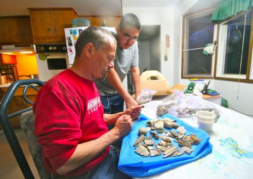 Photo by Vanda Fleuy Elder Keith Anderson and Frank Jr Dysart of Leaf Rapids - examining ancient pottery sherds after Archaeology expedition on Churchill River. for Carol Sanders story in Winnipeg Free Press