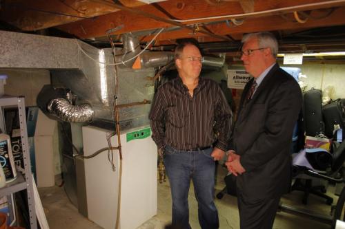 Home owner Bert Heinrichs talks to Manitoba Premier Greg Selinger in the basement of his home where he put in a high efficiency electric furnace. At press conference for new program for people who want to make their homes more efficient. May 8, 2012  BORIS MINKEVICH / WINNIPEG FREE PRESS