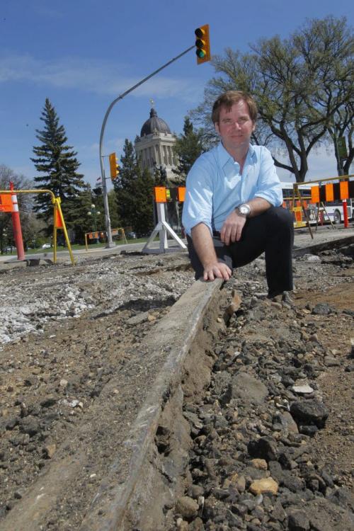 Steven Stothers, Co-chairman of the restoration committee for Winnipeg Streetcar 356 poses for some photos at Broadway and Osborne where some old tracks are being dug up.  May 9, 2012  BORIS MINKEVICH / WINNIPEG FREE PRESS
