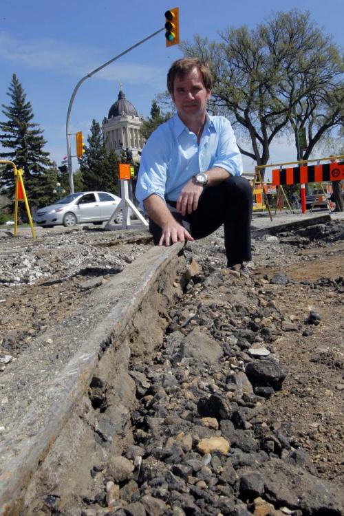 Steven Stothers, Co-chairman of the restoration committee for Winnipeg Streetcar 356 poses for some photos at Broadway and Osborne where some old tracks are being dug up.  May 9, 2012  BORIS MINKEVICH / WINNIPEG FREE PRESS