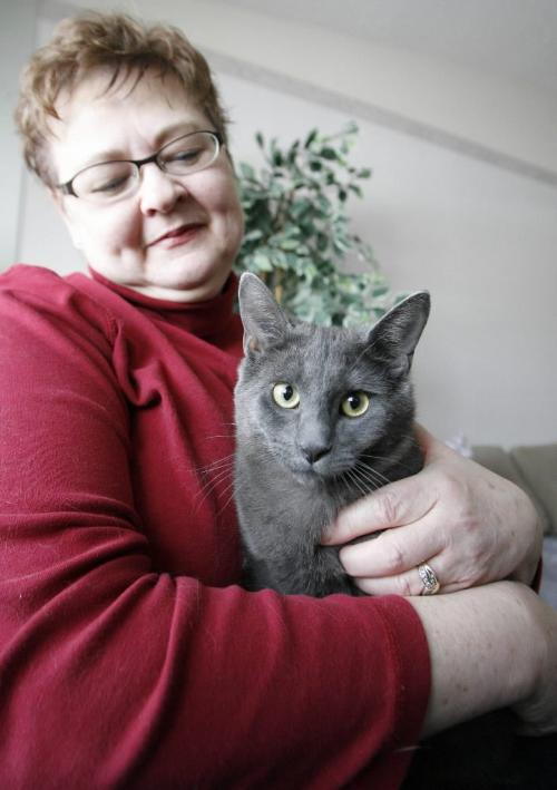 John Woods / Winnipeg Free Press / February 11/07- 070211  - Linda Toews, a Humane Society volunteer, with her rescued cat Loading Dock Larry (or Recyclable Robert) in her home Sunday Feb 11/07.