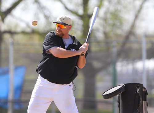 Brandon Sun Faron Asham hits grounders out to his ball players during Sunday's practice at Andrews Field. (Bruce Bumstead/Brandon Sun)