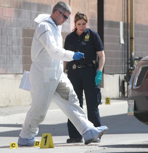 A man found in an alley just south of Maryland Street and Sargent Avenue early today has become the city's 15th homicide victim of the year. The man was conveyed to hospital in critical condition where he later died.-Here Winnipeg Police Service forensic officers gather evidence near noon Thursday- See Gabrielle Giroday story- May 17, 2012   (JOE BRYKSA / WINNIPEG FREE PRESS)