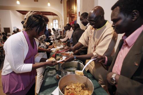 May 20, 2012 - 120520  -  (R to L) Kuac Madit, Ashuein Alor, Jurkuc Yaak and other South Sudanese men serve meals to community women at St Matthews Anglican Church Sunday May 20, 2012.  This is a break from Sudanese tradition as men do not cook or serve women. John Woods / Winnipeg Free Press