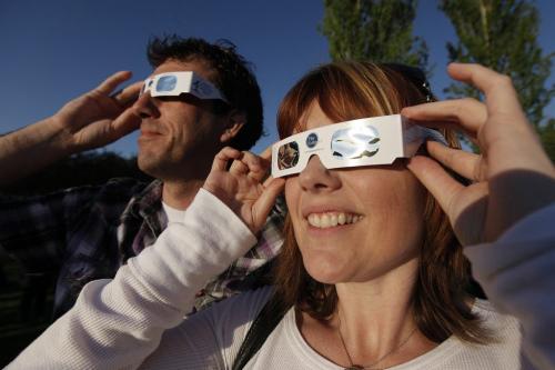 May 20, 2012 - 120520  -  Curious star gazers Denise Wolfram and Raith Tymchak catch a glimpse of the solar eclipse through mylar glasses at Assiniboine Park. Winnipeggers hit Assiniboine Park to catch a glimpse of a partial eclipse Sunday May 20, 2012.    John Woods / Winnipeg Free Press