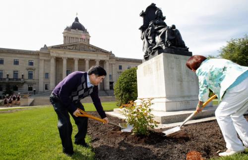 Lt.-Gov. Philip S. Lee and Culture, Heritage and Tourism Minister Flor Marcelino plant two Amber Jubilee Ninebark shrubs beside the statue of Queen Victoria on the north lawn on the grounds of the Manitoba Legislative Building in honour of Queen Elizabeth's Diamond Jubilee on Victoria Day.  120521 May 21, 2012 Mike Deal / Winnipeg Free Press