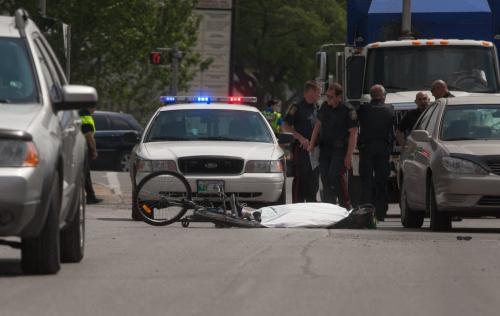 Police investigate after a female cyclist was struck and killed on Higgins Ave just west of Main Street on Wednesday morning.  120523 - Wednesday, May 23, 2012 -  Melissa Tait / Winnipeg Free Press