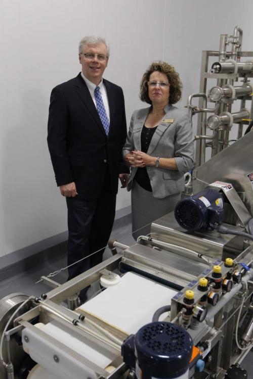 FOOD DEVELOPMENT CENTRE-Portage la Prairie. Premier Greg Selinger and Lynda Lowry from the Food Development Centre pose for a photo with some machinery there. May 25,  2012  BORIS MINKEVICH / WINNIPEG FREE PRESS