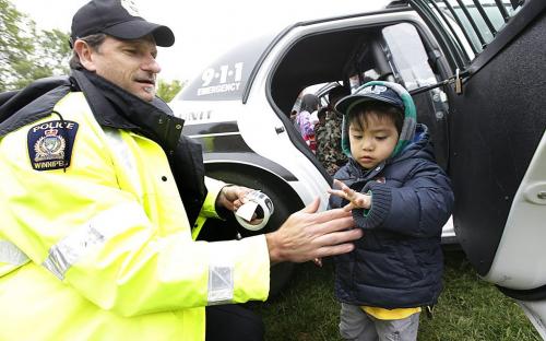 May 27, 2012 - 120527  - Raphael Anero gets a sticker from Const. Derek Siemann at the 26th annual Teddy Bear's Picnic at Assiniboine Park Sunday May 27, 2012 .  John Woods / Winnipeg Free Press