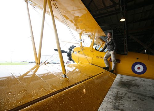 Brandon Sun Vintage Wings of Canada pilot David Maric poses by the cockpit of the Boeing Stearman biplane which he has been flying across Canada to promote the history of the planes and the men who flew them in the British Commonwealth Air Training Plan. This Stearman flew in the BCATP in Bowden, Alta., in 1942. When Maric is volunteering with time flying for Vintage Wings, he can be found at the controls of his other Boeing with Westjet airlines. (Bruce Bumstead/Brandon Sun)