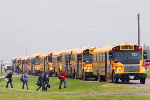 Brandon Sun 28052012 School buses line up outside Elton Collegiate in Forrest, Man. as students leave school at the end of the school day on Monday. (Tim Smith/Brandon Sun)