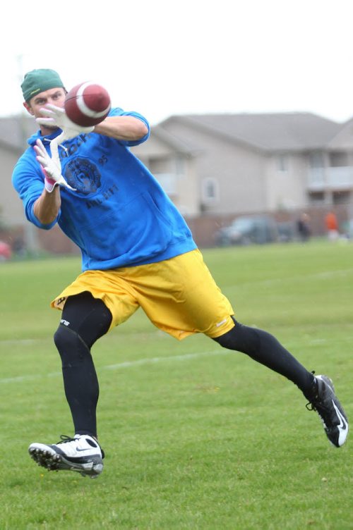 Brandon Sun 28052012 Chris Bauman of the Calgary Stampeders makes a catch while attending practice with the Vincent Massey Vikings High School football teams (Varsity and Junior Varsity) at VMHS on Monday afternoon. (Tim Smith/Brandon Sun)