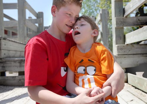Griffin shares a quiet moment with his seven year old brother Tyler who has cerebral palsey on the schools play structure over the lunchhour.  See ongoing series on the class of 2017( at Windsor School. See Doug Speirs story Windsor School 2017 project. May 28  2012 (Ruth Bonneville/Winnipeg Free Press)