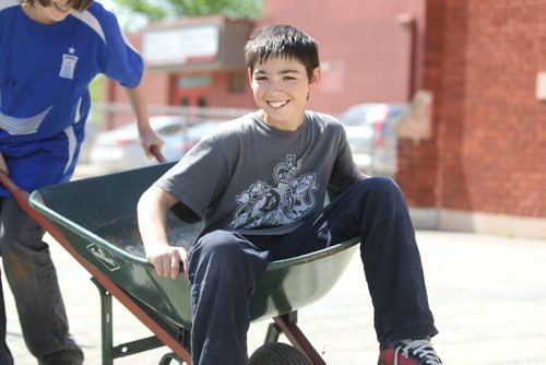 Thomas takes a ride in a wheel barrell while working on cleaning up the schools garden beds for spring planting.  See Doug Speirs story Windsor School 2017 project. May 28  2012 (Ruth Bonneville/Winnipeg Free Press)