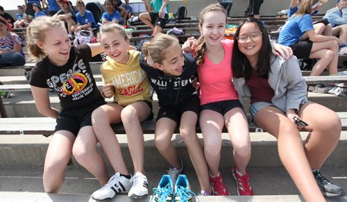 A group of grade 7 girls  lock arms as they hang out together while competing at their city wide track meet at Max Bell track.  Names from right   - Han, Sidney Shaelyn, Aby and Heiley. See Doug Speirs story Windsor School 2017 project. May 28  2012 (Ruth Bonneville/Winnipeg Free Press)