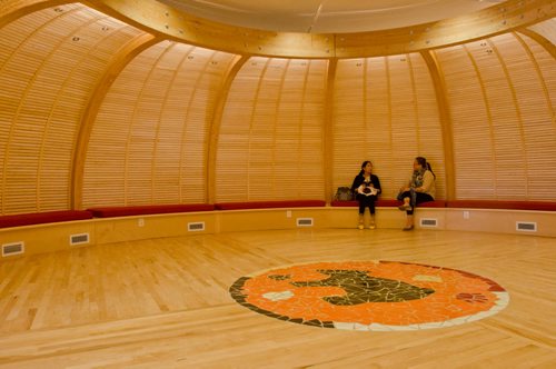 Two women converse in the newly opened Makoonsag intergenerational Children's centre while one holds a small infant on her lap. The centre's name means 'Many Little Bears'.(Photo by Cole Breiland/ Winnipeg Free Press)