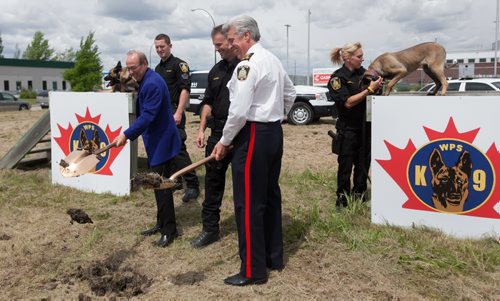 Mayor Sam Katz breaks ground with Winnipeg Police Service Chief Keith McCaskill (right) and Patrol Sgt. David Bessason on the new Canine Unit building soon to be constructed beside the East District Police Station. In the background is police service dog Riley (left) with handler Const. Jeff Katcher and Rane with handler Const. Loray Scott. 120601-  Friday, June 1, 2012 Melissa Tait / Winnipeg Free Press