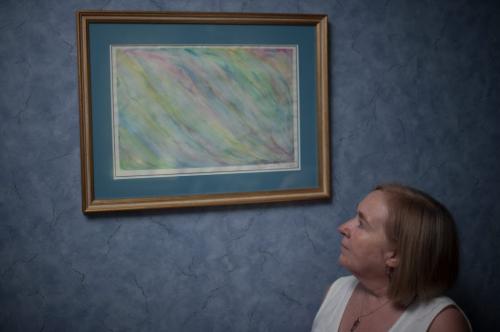 Elaine Stevenson looks at a painting her daughter Alyssa made when she was happier and used colour instead of black and white.  A penciled note at the bottom right of the painting reads 'To Mom, Dad / I love you so much / Thank you for everything / Alyssa'.  (Photo by Cole Breiland/ Winnipeg Free Press) Winnipeg Free Press