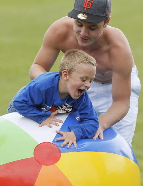 June 3, 2012 - 120603  -  Corey Derkach plays with his nephew Caden Dolph and a huge beach ball at Party For The Park at Assiniboine Park Sunday June 3, 2012.    John Woods / Winnipeg Free Press