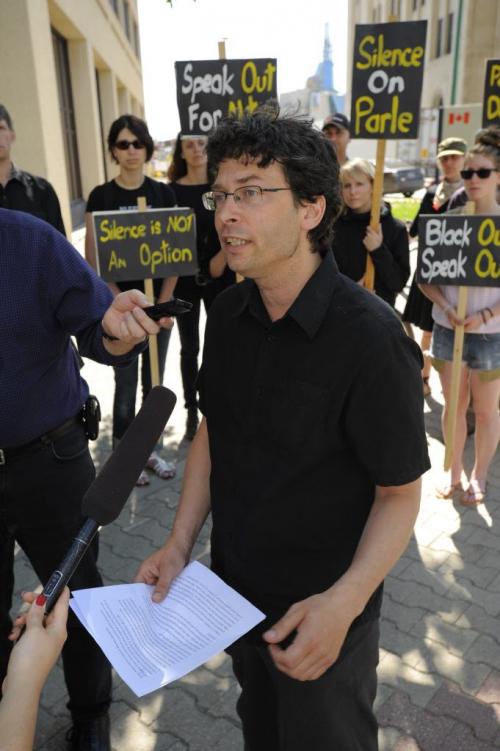 Josh Brandon of the Green Action Centre  about the Black Out Speak out Protest outside the Canadian Grain Commission Building on Main Street in downtown Winnipeg on June 4th, 2012. Black Out Speak Out will see participating websites shut down to protest the omnibus bill C-38, that they claim will harm meaningful environmental review of industrial projects in Canada. (Photo by Cole Breiland / Winnipeg Free Press) Winnipeg Free Press
