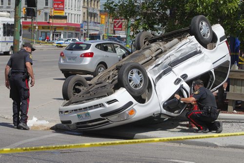 MVC roll over at the corner of Sherbrook and Portage Ave. June 5, 2012  BORIS MINKEVICH / WINNIPEG FREE PRESS