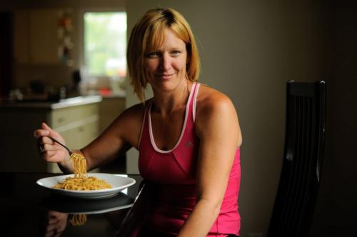 Kris Wood is about to begin carbing up for the upcoming Manitoba Marathon.  Wood prefers butter to sauce for her noodles.  Her pre-race snack will be a bagel, peanut butter, and bananas. (Photo by Cole Breiland / Winnipeg Free Press) Winnipeg Free Press