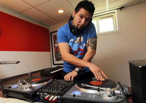 Milad S. Darani aka DJ Euphoria comments about the music licensing laws. Here he poses for a photo in his basement with his DJ equipment. June 6, 2012  BORIS MINKEVICH / WINNIPEG FREE PRESS