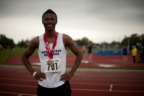 River East Collegiate student Alhaji Mansaray accepts his gold medal in the 100-metre dash with a time of 11.82 on June 8th, 2012. He also topped the high jump standings with a 2.0 metre leap. (Photo by Cole Breiland / Winnipeg Free Press) Winnipeg Free Press