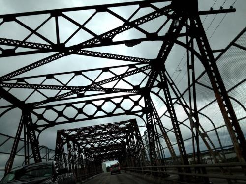 The lines of the Arlington Bridge are painted over grey clouds of the gloomy Monday weather.The Arlington Bridge opened on February 5, 1912 and celebrates it's 100th birthday this year. June 11, 2012  BORIS MINKEVICH / WINNIPEG FREE PRESS