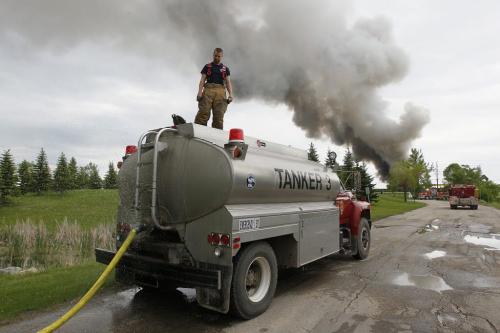 June 12, 2012 - 120612  - A firefighters from Springfield fills a tanker as firefighters from Winnipeg and Springfield rush to put out a scrap fire at General Scrap on Springfield Road in Winnipeg Tuesday June 12, 2012.  John Woods / Winnipeg Free Press