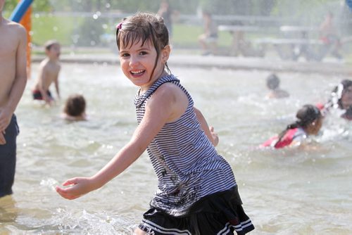 Four year old Caitlyn Dunning is all smiles as she  runs with her cousins through the pool n the new spray pad that opened called the  Eldon Ross Wading Pool (Pacific Dee Park) Thursday afternoon. Standup photo. June 14  2012 (Ruth Bonneville/Winnipeg Free Press)