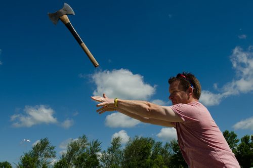 Winnipeg Free Press reporter Geoff Kirbyson  learns to throw a lumberjack's axe at the Red River Ex, on it's June 15th, 2012 opening. (Photo by Cole Breiland / Winnipeg Free Press) WInnipeg Free Press