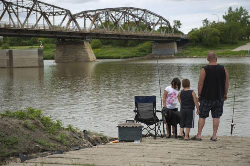 DAVID LIPNOWSKI / WINNIPEG FREE PRESS 061712 Wesley Duscharme and children Nathan (age 5) and Olivia (age 8) were fishing on the Red River by the Louise Bridge on Fathers Day Sunday, when they saw a man washed up on the shore. The man reportedley jumped from a bridge, and was taken away by ambulance. June 17 2012.