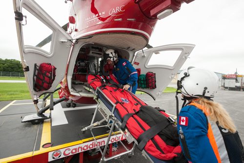 Flight nurse Rhonda Kaluzny (foreground) and flight paramedic Grant Therrien load a stretcher into the back of the STARS air ambulance, a Eurocopter BK117. 120619 - Tuesday, June 19, 2012 -  Melissa Tait / Winnipeg Free Press