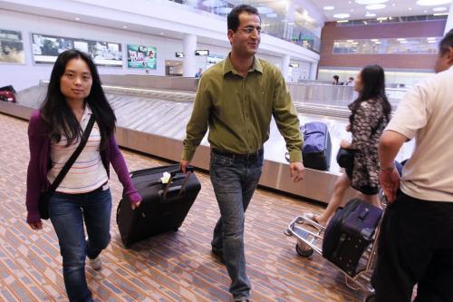 June 19, 2012 - 120619 - At Richardson International Airport in Winnipeg Kamal Solaimani (right) and Ying Ying Liu commented after hearing that the federal government put cameras and microphones in Ottawa Airport to eavesdrop on passengers Monday June 19, 2012.  John Woods / Winnipeg Free Press
