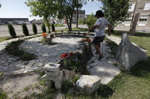 June 25, 2012 - 120625  -  Ronald Ross spends time in a memorial garden to murdered and missing women on Sutherland at Main which was built by Vineyard Church Monday, June 25, 2012.    John Woods / Winnipeg Free Press