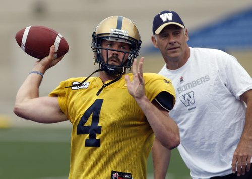 STDUP - HANDS ON COACH- Offensive Co ordinaor  Gary Crowton  keeps a close eye  during QB accuracy and footwork drill with QB Buck Pierce  at Canad Inn Stadium practice  - adam wozny story  -KEN GIGLIOTTI  / WINNIPEG FREE PRESS  /  June 26 2012