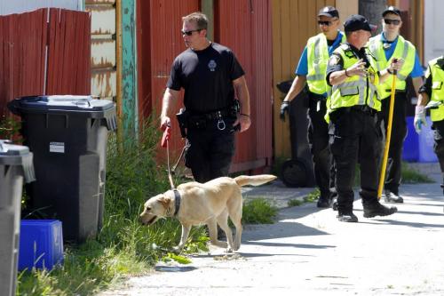 Police dogs and cadets search the back lane of the odd side of Simcoe near Notre Dame for evidence. June 28, 2012  BORIS MINKEVICH / WINNIPEG FREE PRESS