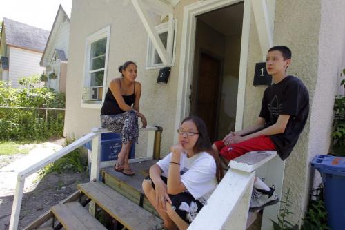 Tanya Roberts, Denise Bone and an un named kid  sit on a porch on Simcoe near the area police were searching today. June 28, 2012  BORIS MINKEVICH / WINNIPEG FREE PRESS