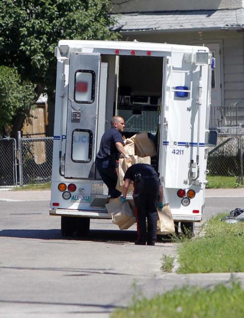 Police work near Euclid and Sutherland. Here ident loads up boxes into the back of their truck from the arrest scene. June 29, 2012  BORIS MINKEVICH / WINNIPEG FREE PRESS
