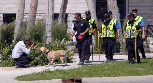 Police search for evidence near Euclid and Sutherland. Here a news photographer gets sniffed by the fire commissioners dog. Media was instructed to stay 50 ft away from the police dog. June 29, 2012  BORIS MINKEVICH / WINNIPEG FREE PRESS