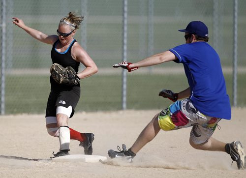 Krista Johnson, 25, of Team Goodwood, beats Justin Glays, 25, of Team Bombsquad, to get the out at third base during the Canada Day Slo Pitch Tournament at Buhler Recreation Park, Saturday, June 30, 2012. (TREVOR HAGAN/WINNIPEG FREE PRESS)