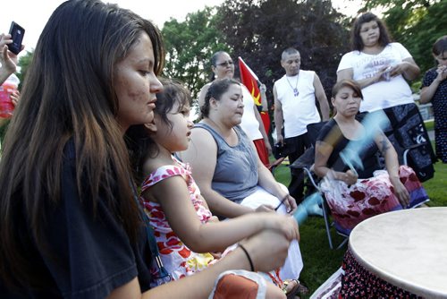 Kelly Chinchilla, and her daughter, Rylee, 3, left, play the drum at a vigil held for Carolyn Sinclair, Lorna Blacksmith and Tanya Nepinak, at Memorial Park, Saturday, June 30, 2012. (TREVOR HAGAN/WINNIPEG FREE PRESS)