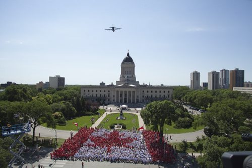 Handout photo of thousands of Winnipeggers wearing red and white t-shirts gathered at the legislative grounds in Winnipeg July 1, 2012 to form a human flag as part of Canada Day celebrations.    HANDOUT PHOTO: RON GILFILLAN / DOWNTOWN BIZ